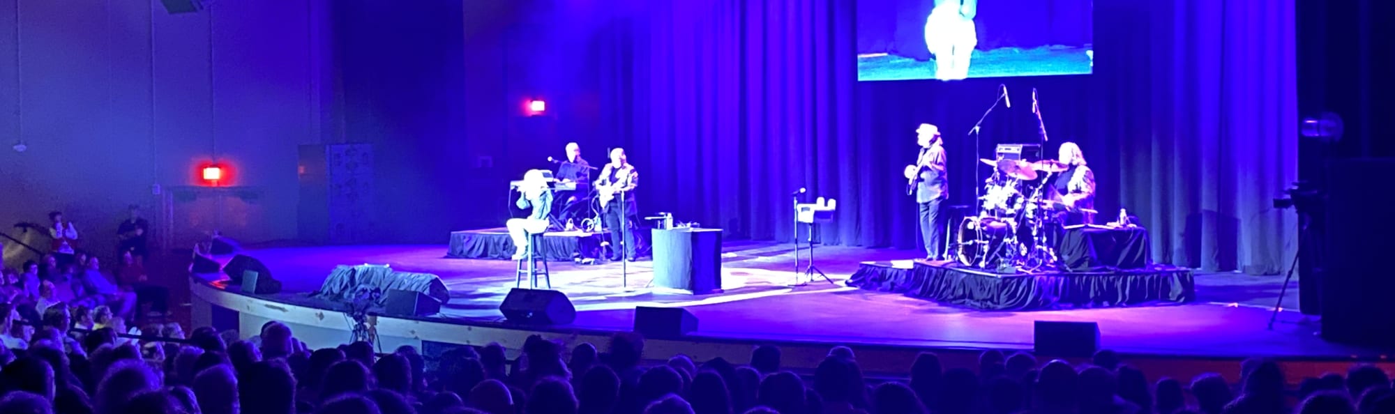 signer on stage in chair washed out by the lights Sacramento